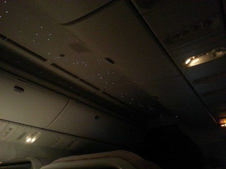 This airplane has stars in the ceiling at night.